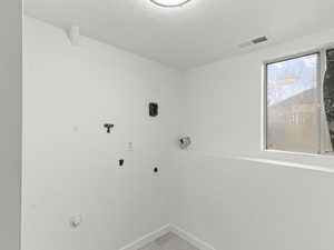 Laundry room featuring a textured ceiling and washer hookup