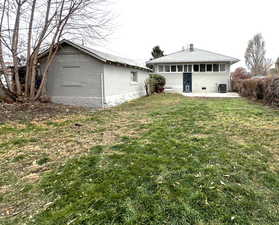 Rear view of house featuring a yard and seperate entry for Mother-In-Law space.