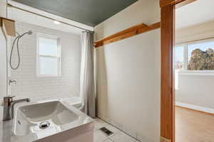 Full bathroom featuring shower / bath combo, light tile patterned floors, and vanity