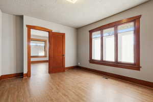 Master Bedroom featuring a textured ceiling and light wood-style floors