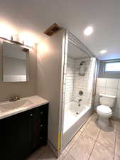 Full 2nd bath with vanity,  shower combination, light tile patterned flooring, recessed lighting, and tile walls.
