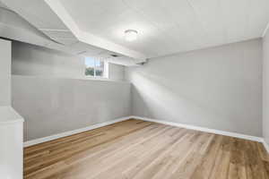 MIL - Bedroom #3 with light wood-style floors and baseboards