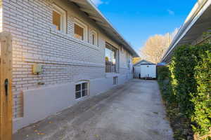 View of side of home with brick siding and detached garage