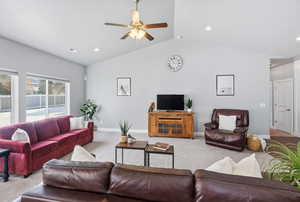 Carpeted living room with ceiling fan, lofted ceiling, and recessed lighting