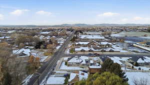 Snowy aerial view with a residential view and a mountain view