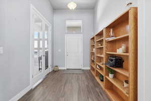 Interior space featuring dark wood-style floors and baseboards
