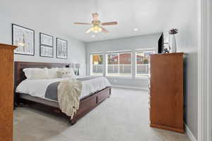 Primary Bedroom featuring light carpet, a ceiling fan, and recessed lighting