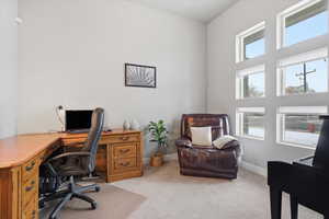 Office off of entry featuring healthy amount of natural light and light carpet