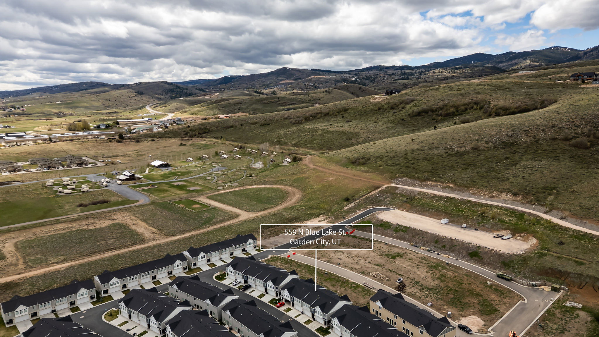 Aerial perspective of suburban area featuring a mountainous background