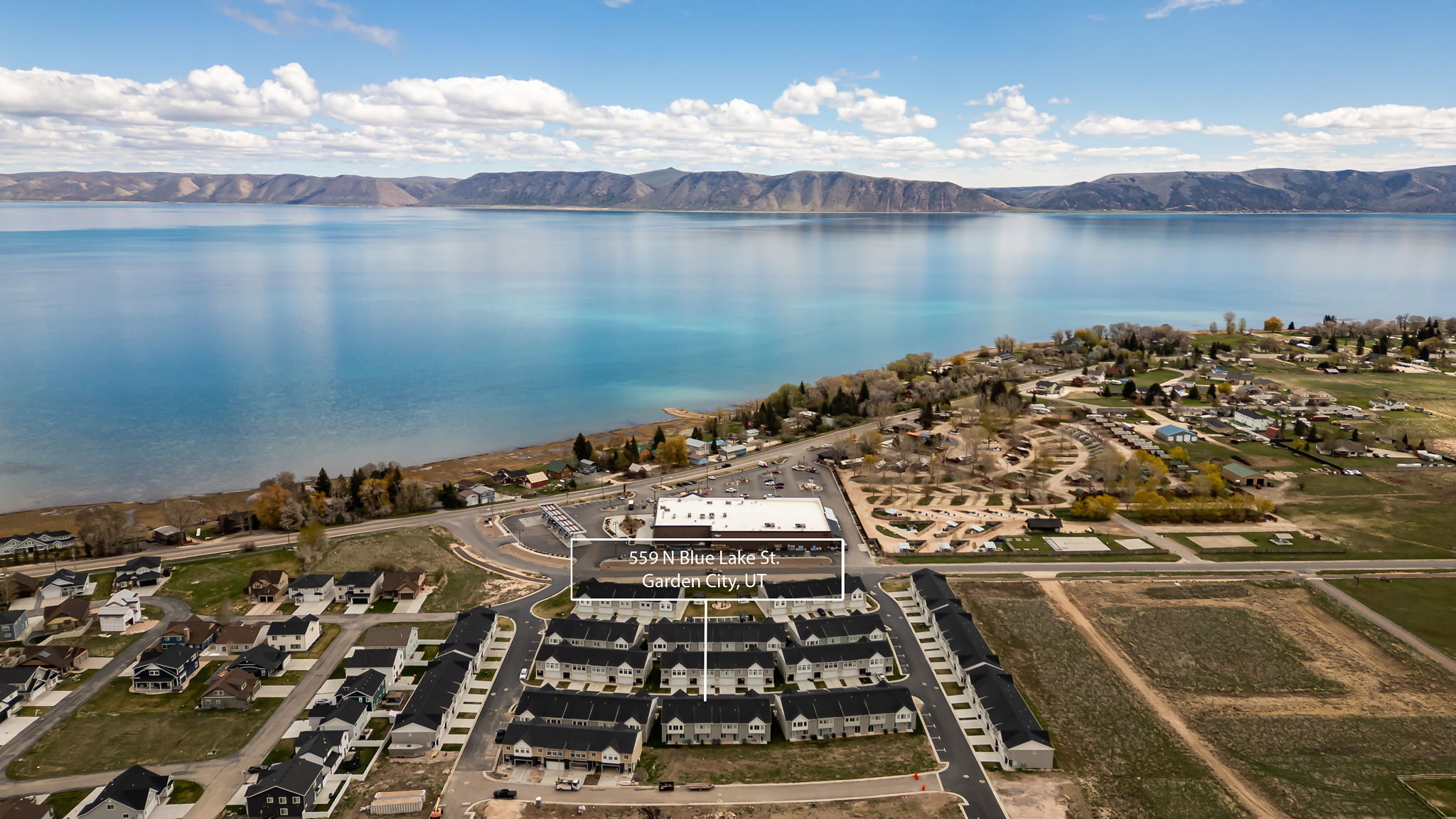 Aerial perspective of suburban area with a water and mountain view