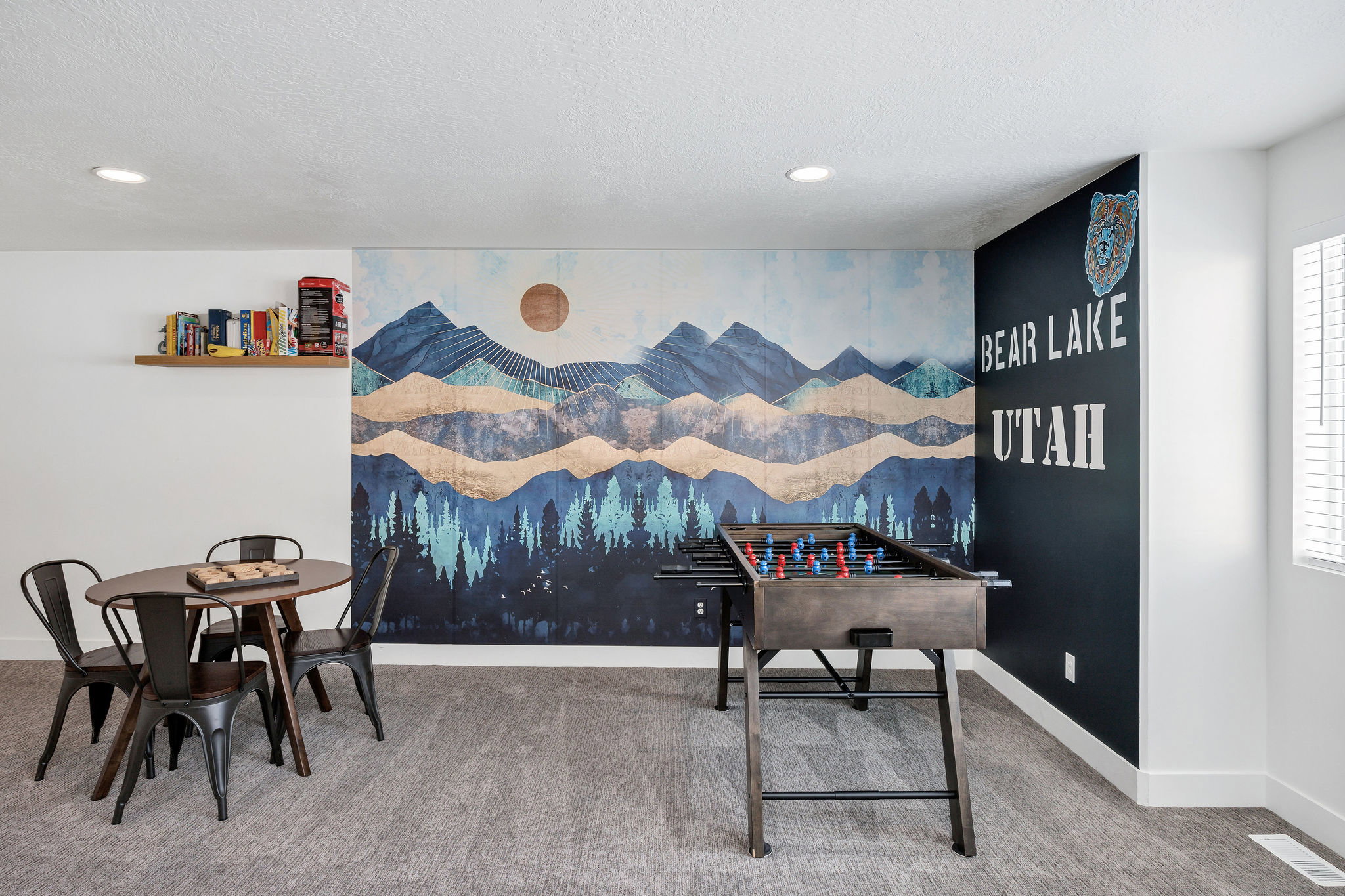 Rec room with an accent wall, carpet floors, a textured ceiling, and recessed lighting