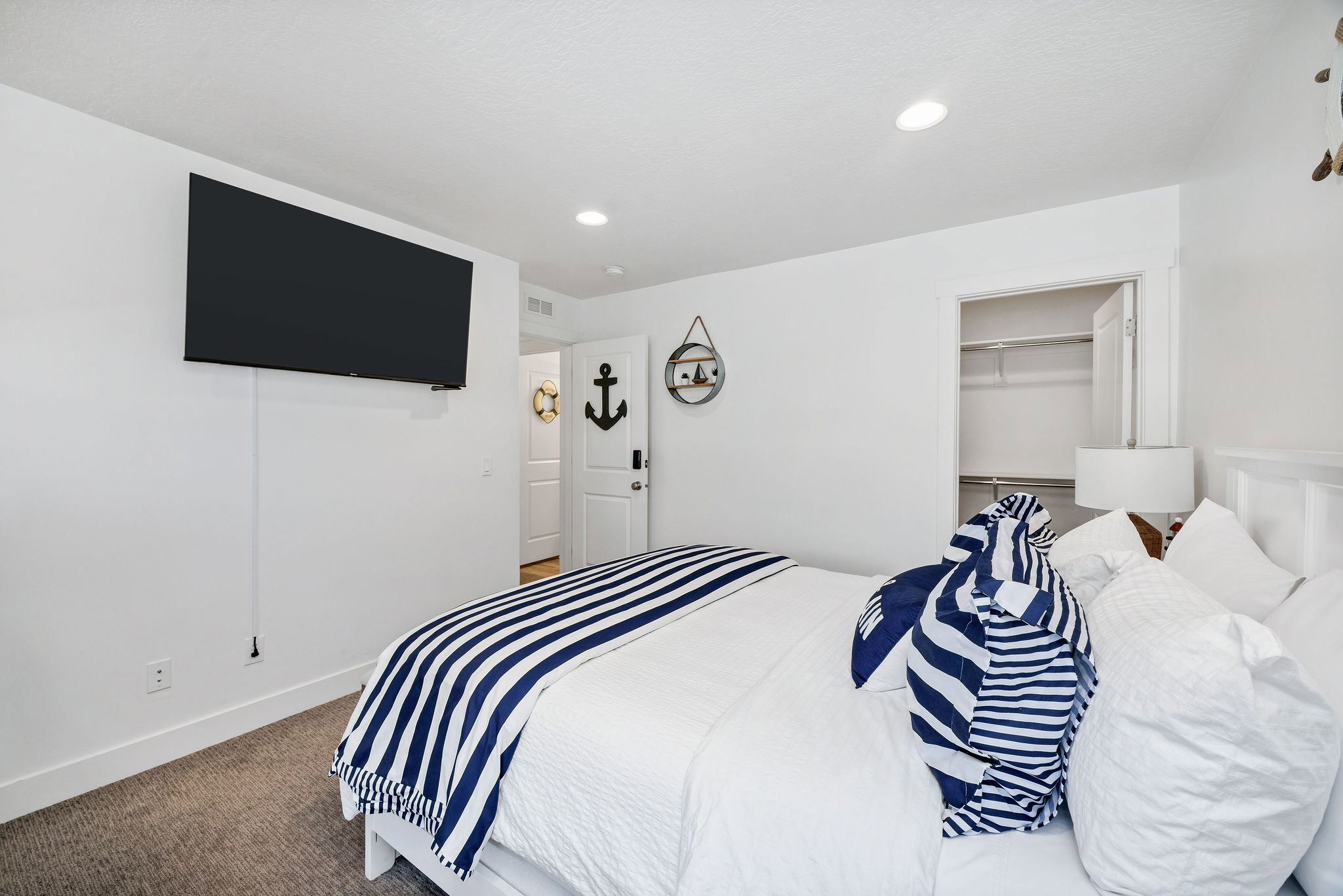 Carpeted bedroom featuring recessed lighting and a walk in closet