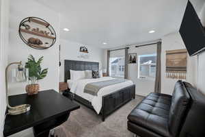 Carpeted bedroom with recessed lighting