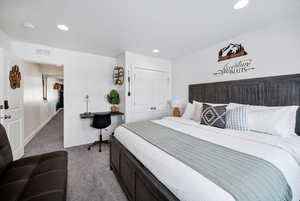 Bedroom with carpet floors, a closet, and recessed lighting
