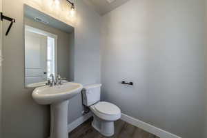 Bathroom featuring baseboards and wood finished floors