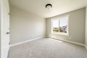 Unfurnished room featuring baseboards and carpet