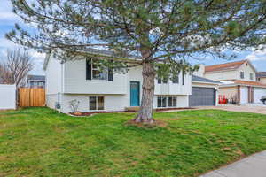 Bi-level home featuring brick siding and driveway