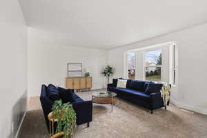 Bright living room with new carpet and large windows