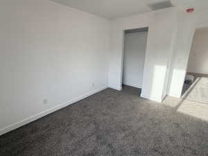 Unfurnished bedroom featuring carpet flooring and a closet