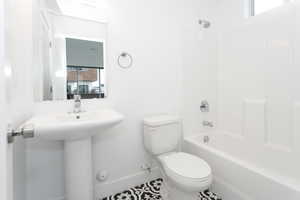 Bathroom featuring plenty of natural light and  shower combination