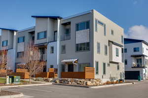 View of building exterior featuring uncovered parking