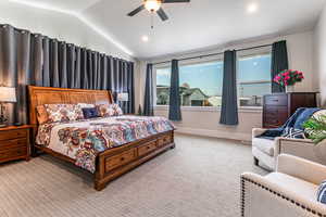 Bedroom featuring lofted ceiling, light colored carpet, a ceiling fan, and recessed lighting