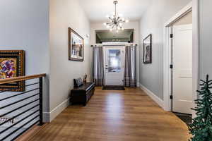 Entryway with a chandelier and wood finished floors