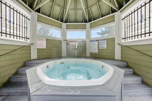 View of pool with a community hot tub and a gazebo
