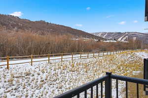 View of yard with a mountain view and a balcony