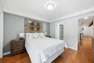 Bedroom featuring wood finished floors and ensuite bath