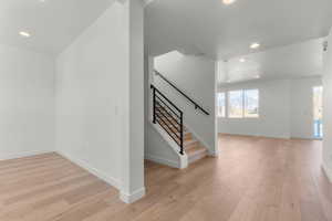 Stairs with recessed lighting and wood-type flooring
