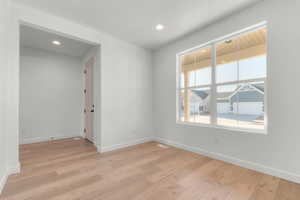 Spare room with light wood-type flooring and recessed lighting