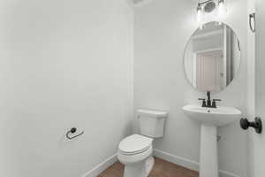 Bathroom featuring baseboards and wood finished floors