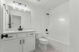 Full bath featuring  shower combination, vanity, and light tile patterned floors