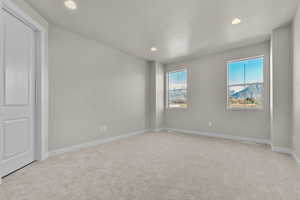 Unfurnished room with light carpet and recessed lighting