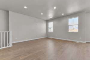 Unfurnished room featuring light wood-type flooring and recessed lighting