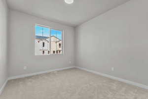 Empty room with baseboards and carpet
