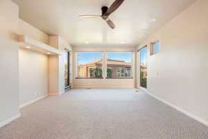Carpeted spare room featuring ceiling fan and recessed lighting