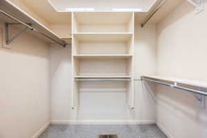 Walk in closet featuring carpet flooring
