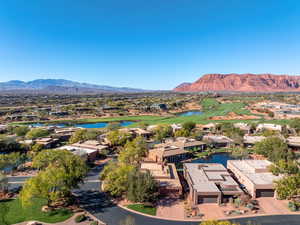 Aerial perspective of suburban area with a water and mountain view and a local golf course