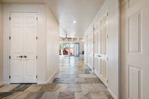Hall featuring recessed lighting and stone tile flooring