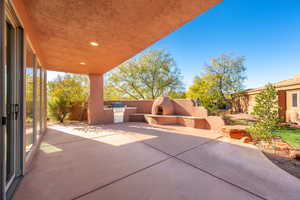 View of patio / terrace with an outdoor kitchen and exterior fireplace