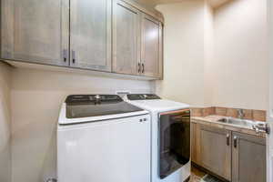 Washroom with cabinet space and independent washer and dryer