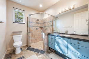 Bathroom featuring vanity and a shower stall