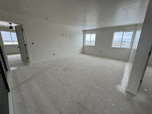 Empty room with baseboards and a textured ceiling