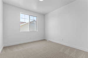 Spare room with light colored carpet