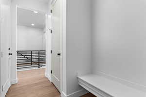 Hallway featuring light wood finished floors and recessed lighting