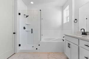 Bathroom with vanity, a bath, light marble finish flooring, and a stall shower