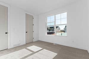 Unfurnished room with baseboards and carpet