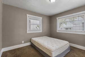 Carpeted bedroom featuring baseboards